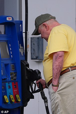 A man fills up in the Dallas suburb of Richardson, Texas, Wednesday, May 6