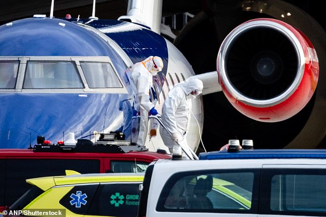 A patient is seen leaving an aircraft at Schiphol-East - boarded by medical evacuees from the MV Hondius on May 6