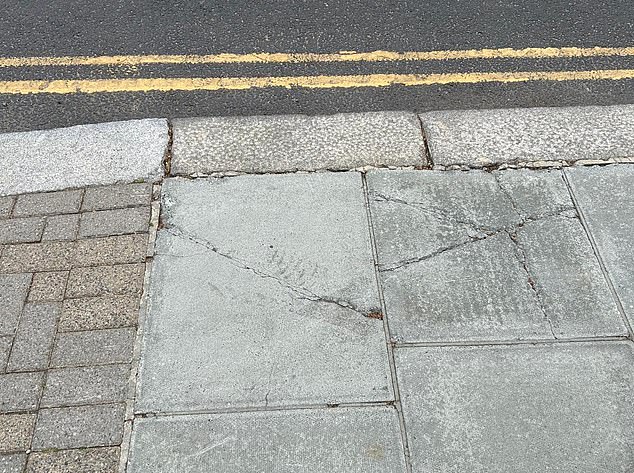 Paving slabs have cracked and crumbled where they go under the lorries' wheels