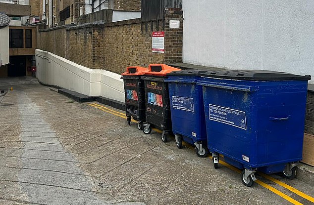 Four bins used by Whole Foods have been moved up against Thackeray House