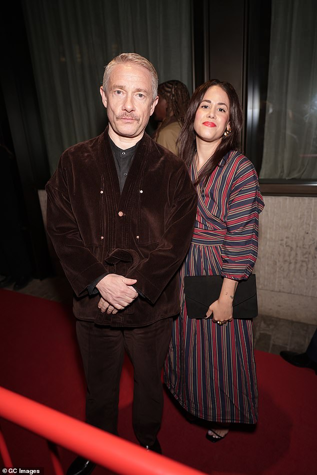 The Sherlock star, 54, cut a dashing figure in a brown suede suit which boasted a quirky belted blazer and was worn over a dark T-shirt