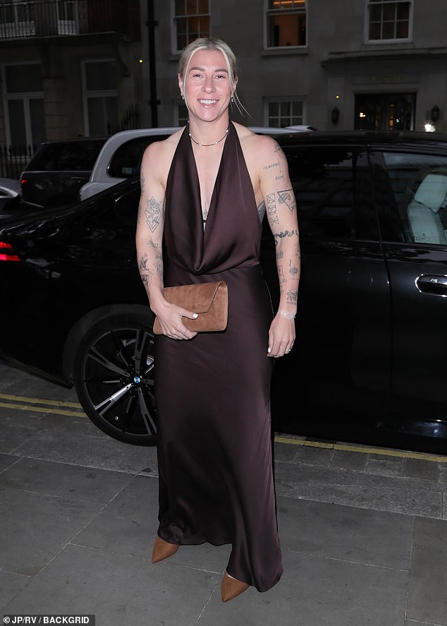 Bethany England turned heads in a brown satin plunging gown which she paired with a suede clutch and stilettos