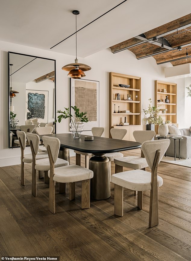The open design floor plan leads to the kitchen and dining area where a long table is able to easily fit