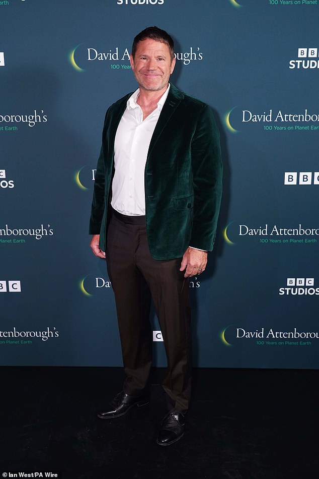 Steve Backshall smiled for photos in a deep green blazer