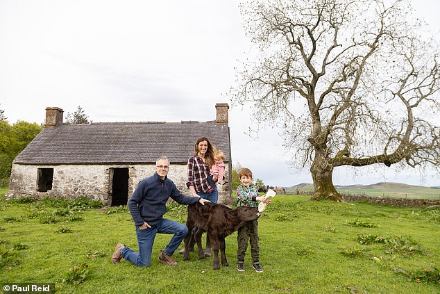 Rowan is pictured feeding a cow in Dundee with his parents, Lorenzo and Virginia, and his one-year-old sister