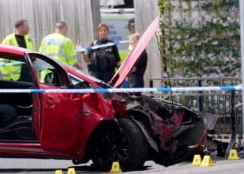 Man, 40, arrested after car ploughed into people in busy high street following 'argument' leaving one fighting for life