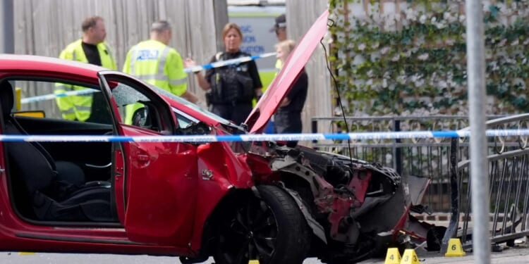 Man, 40, arrested after car ploughed into people in busy high street following 'argument' leaving one fighting for life