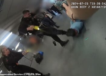 Firearms officer PC Zachary Marsden kicks Mohammed Fahir Amaaz, now 21, in the face during the fracas at Manchester Airport in July 2024 (pictured on footage from a colleague's body-worn camera)