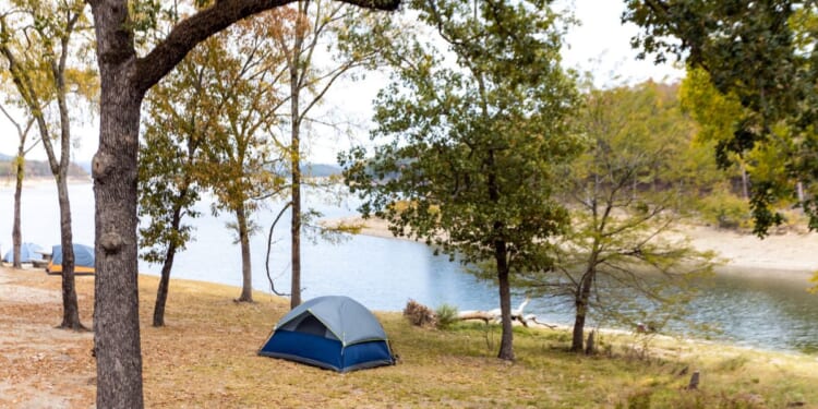 Camping tents near a beautiful lake among trees at Broken Bow Lake in Oklahoma.