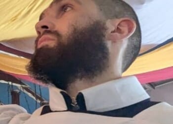 Young monk Justin Evans, 24, is described as being around 6ft tall, with short hair and a dark beard