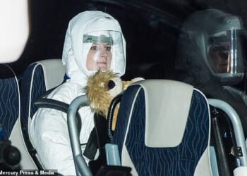 Pictured: A woman in a protective suit on a coach containing British citizens flown out of Wuhan arrives at Arrowe Park Hospital in Wirral during the Covid pandemic in 2020