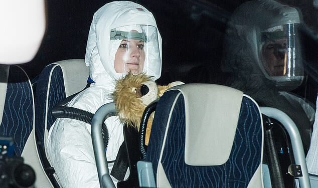 Pictured: A woman in a protective suit on a coach containing British citizens flown out of Wuhan arrives at Arrowe Park Hospital in Wirral during the Covid pandemic in 2020