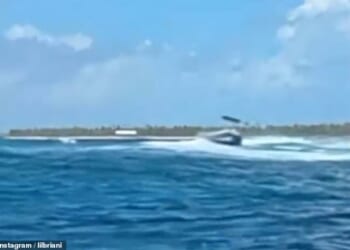 A tourist lost a leg and another was left seriously hurt after an unmanned diving boat spun out of control and sped over a group in the water when its skipper was knocked overboard. Pictured: The boat out of control