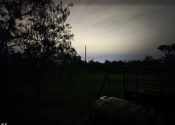 An eerie image of Crowell, rural Texas, shows a bright white glow from a new data center cutting through backyard trees