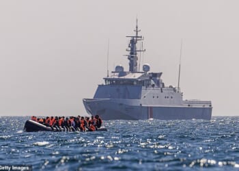 A French Warship escorts an inflatable 'small boat' carrying migrants across the channel towards Britain. Small boat gangs switching cross-Channel smuggling operations from France to Belgium have been hit by an unprecedented wave of arrests