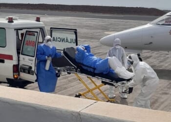 Health workers are seen evacuating a patient from luxury cruise liner MV Hondius, which is the center of a hantavirus outbreak