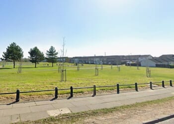 Police are hunting two men after a woman was stabbed in broad daylight in a park in County Durham on Sunday