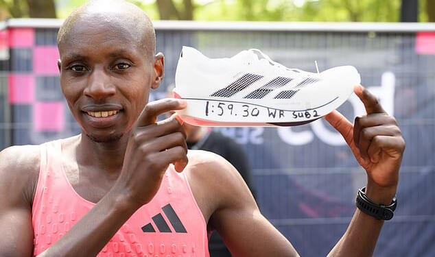Sabastian Sawe poses with his Adidas shoe after his record-breaking London run