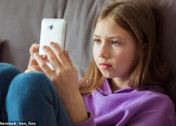 Children aged 10 to 12 are more likely to own a smartphone than know how to throw a ball properly, according to a report (file picture)