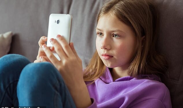 Children aged 10 to 12 are more likely to own a smartphone than know how to throw a ball properly, according to a report (file picture)