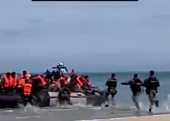 Video released by migrant charity Utopia 56 shows French police sprinting towards a migrant dinghy at Oye-Plage, near Calais, on Sunday morning and deflating it