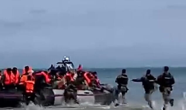 Video released by migrant charity Utopia 56 shows French police sprinting towards a migrant dinghy at Oye-Plage, near Calais, on Sunday morning and deflating it