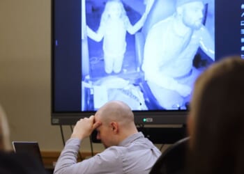 Defendant Tanner Horner reacts April 7 during testimony at the Tim Curry Criminal Justice Center in Fort Worth, Texas. Horner pleaded guilty to capital murder in the November 2022 strangulation killing of 7-year-old Athena Strand. The child is pictured in the video on the screen in the courtroom as Horner drives his FedEx truck.