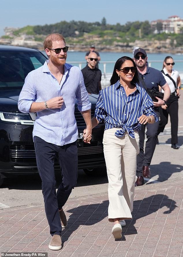 Pictured: Harry and Meghan during their visit to Bondi Beach in Sydney as part of their quasi-royal tour Down Under last month