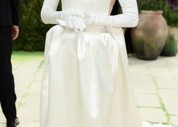 Here comes the AI bride? Katy Perry completely covered her face in a robot-esque silver mask, pairing it with a strapless, white silky gown with an exaggerated square neckline. She finished off the look with a pair of white satin opera gloves