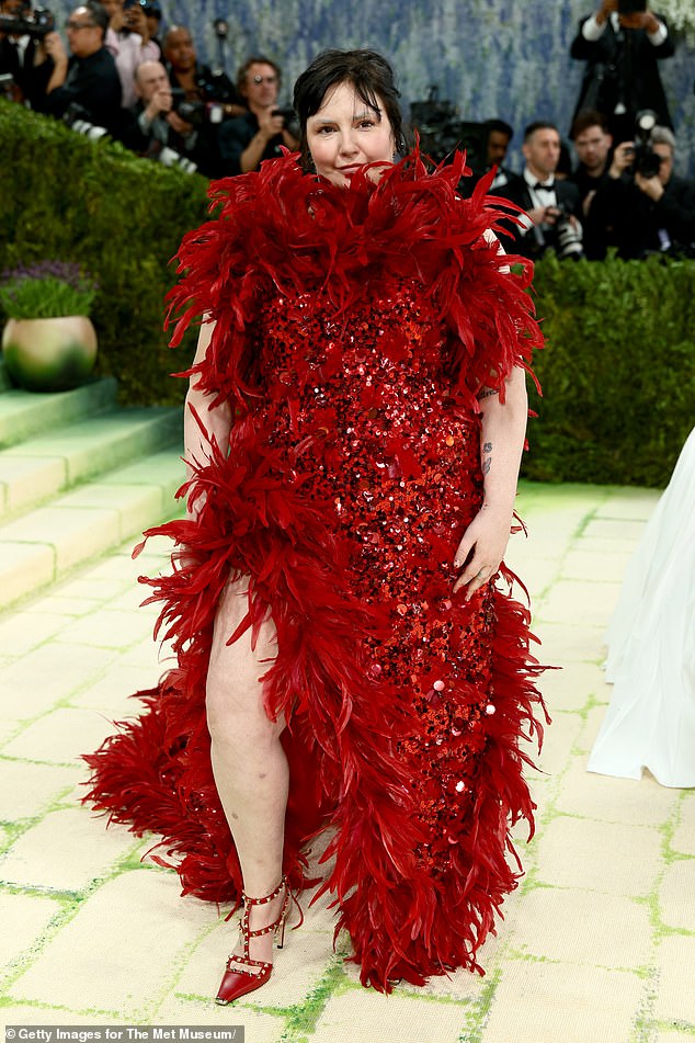 Red hot wrong! Lena Dunham arrived in a custom, red sequined and feathered Valentino gown that is inspired by by Artemisia Gentileschi’s Judith Slaying Holofernes painting, according to Vogue. She paired the look with the brand's signature rockstud heels in bright red, and wore minimal jewelry