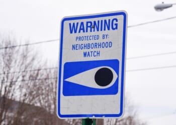 A blue and white neighborhood watch sign.