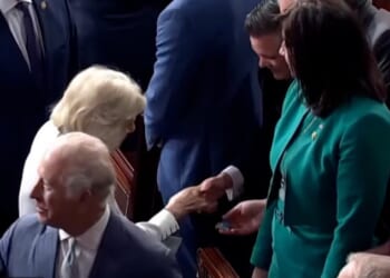 Queen Camilla is handed a token by congressman Jimmy Patronis during her visit to the US