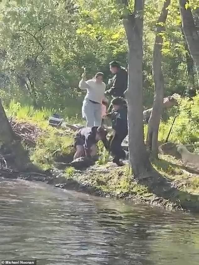 The boy who fell backward then held the beaver down to prevent it from continuing its assault