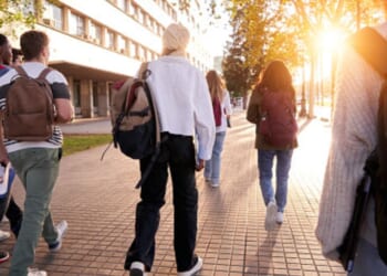 Students walk on a college campus.