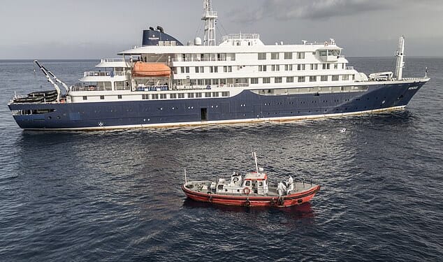 An ambulance boat carrying crew members wearing hazmat suits as they approach MV Hondius, while stationary off the port of Praia, the capital of Cape Verde, on May 5, 2026