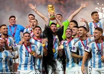 Argentina captain Lionel Messi lifts the FIFA World Cup trophy after winning the 2022 World Cup - US restaurants are bracing for a tipping culture clash during the World Cup this summer