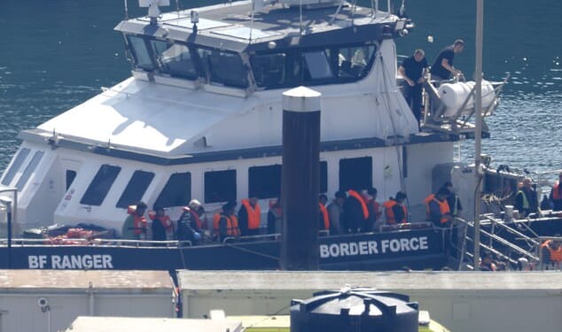 Historic figure: Among the people brought ashore by Border Control yesterday is the man believed to be the 200,000th small-boat migrant, circled