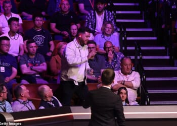 The snooker fan, pictured standing up, was thrown out for a bizarre shout about the Epstein Files