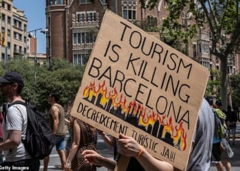 Protestors march during an anti-tourism protest on June 15, 2025 in Barcelona, Spain