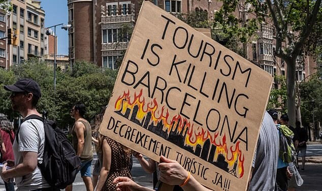 Protestors march during an anti-tourism protest on June 15, 2025 in Barcelona, Spain