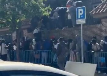 This is the image that shows the folly of Spain's socialist experiment to grant amnesty to 500,000 illegal migrants as dozens invade the Gambian Embassy in Madrid