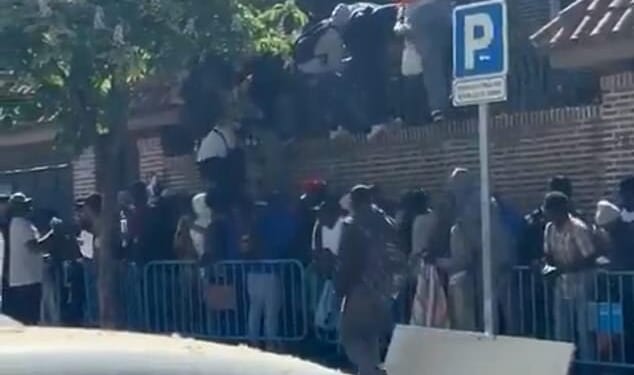 This is the image that shows the folly of Spain's socialist experiment to grant amnesty to 500,000 illegal migrants as dozens invade the Gambian Embassy in Madrid