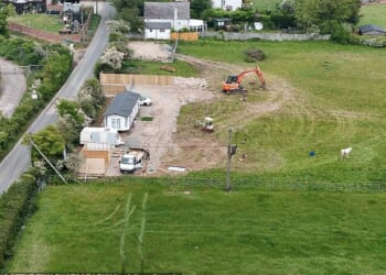 The traveller Bank Holiday land grabs: Army of workers using diggers and lorries drag caravans into villages across Kent and Essex - as councils close for long weekend