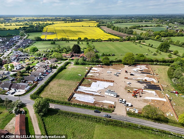 AFTER: An army of workers descended on a four-acre field on Friday, hours after the local district council closed its doors