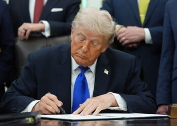 President Donald Trump signs a presidential permit regarding pipeline construction in the Oval Office of the White House Thursday.