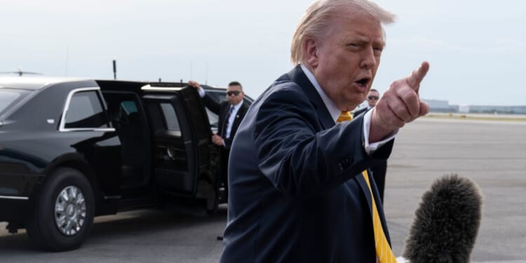 President Donald Trump speaks to journalists before boarding Air Force One at Palm Beach International Airport Saturday in Palm Beach, Florida.