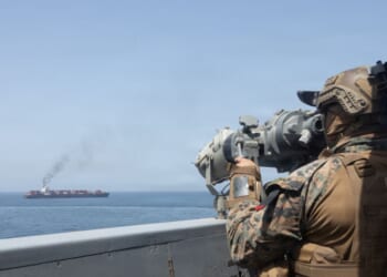 In this handout photo provided by U.S. Central Command, U.S. forces patrol the Arabian Sea near M/V Touska on April 20, 2026, after firing upon the Iranian-flagged vessel that the U.S. accused of attempting to violate the U.S. naval blockade of Iranian ports near the Strait of Hormuz.