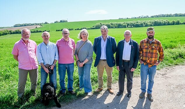 Residents in Hampshire stood in front of the fields at the centre of plans to build an enormous 378-acre housing development known as 'Upper Swallick'