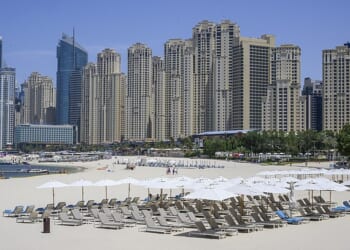 A handful of people spend time on the near-empty beaches in the Jumeirah Beach Residence